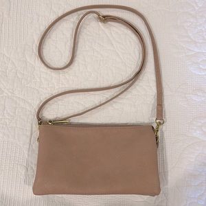 Dusty pink crossbody purse with adjustable strap.